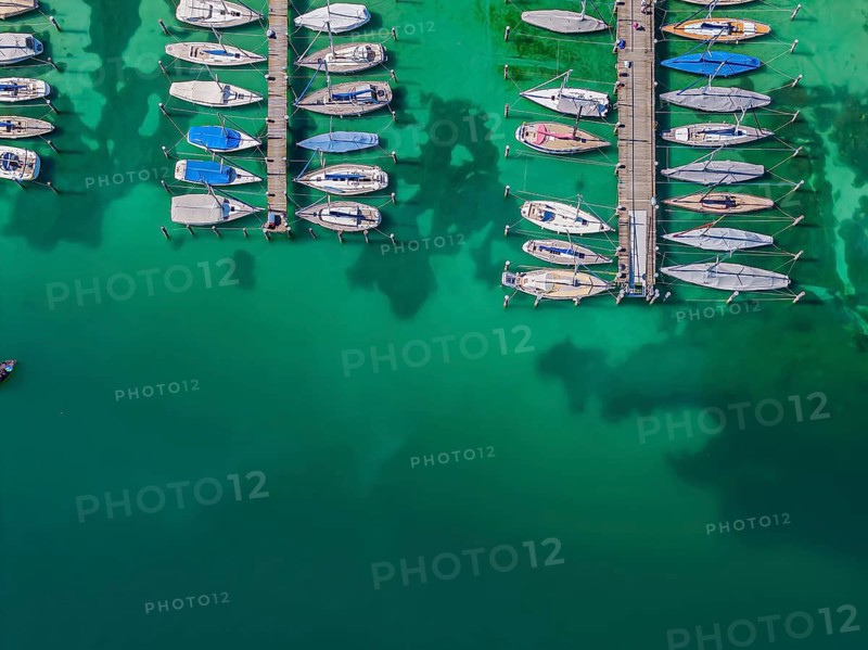 Marina of the Yacht Club Insel Reichenau. The lake bed can be seen in many shallow water zones. The water level of Lake Constance is currently low for the time of year. Reichenau, Baden-Württemberg, Germany