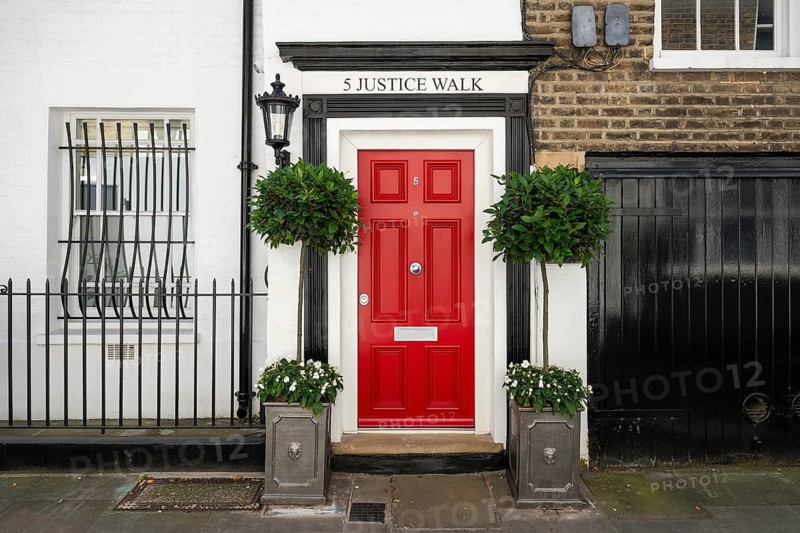 Red door with black edging, plants in pots and decorative lantern, white house facade, 5 Justice Walk, Chelsea, London, Great Britain, England, Great Britain