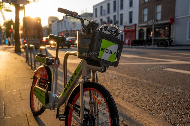 A rental bike is parked on the street at sunset, ready for use in the city, Dublin, Ireland
