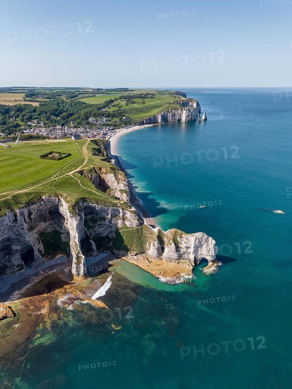 Aerial view of the Falaise d'Amont rock formation with the Porte d'Amont rock gate at low tide, on the horizon the Porte d'Aval rock formation, Étretat, Alabaster Coast, La Côte d'Albâtre, chalk cliffs, English Channel, Seine-Maritime, Normandy, France