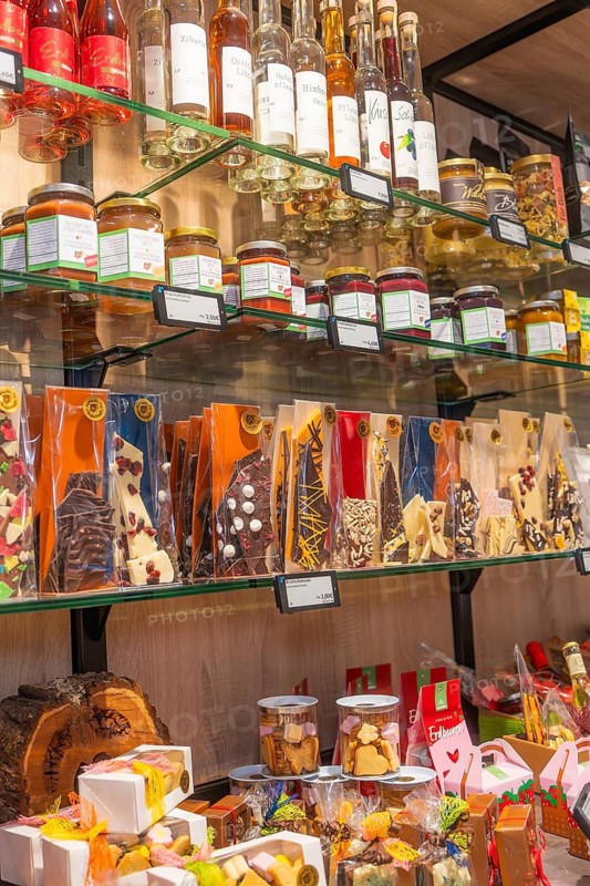 Mixed range of sweets and liqueurs on several glass shelves, Café Kuh, Deckenpfronn, Germany