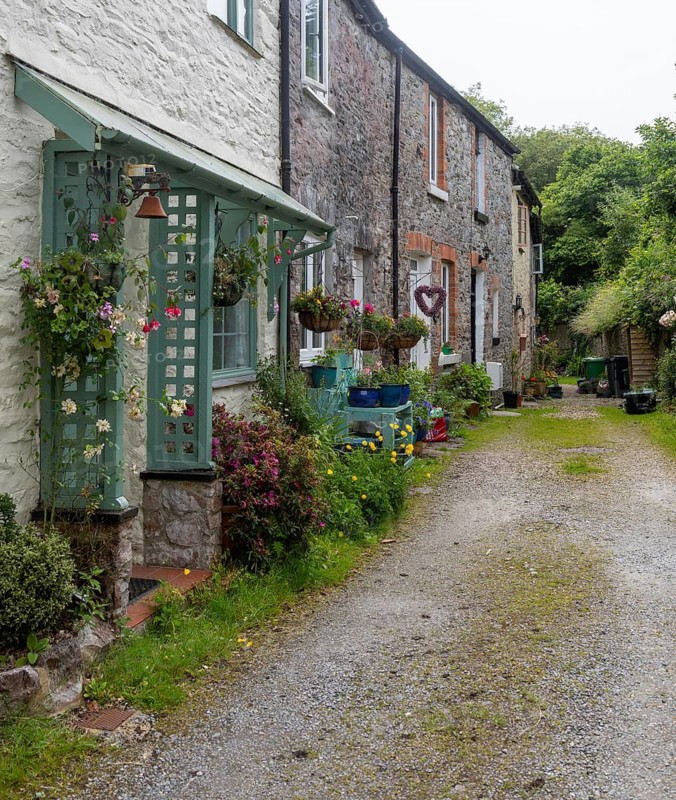 Industrial heritage housing, row of small historic textile wooden mill workers cottages, Buckfastleigh, Devon, England, UK