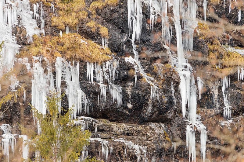 A steep rock face is covered with icicles on a very cold morning. Mühlviertel, Austria