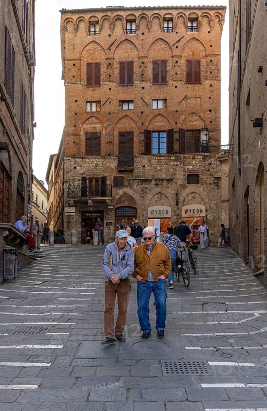 Seniors on their way to Piazza del Campo, Siena, Tuscany, Italy
