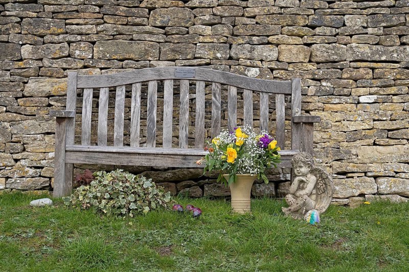 Stone wall, bench, flowers, cemetery, Bibury, The Cotswolds, England, Great Britain