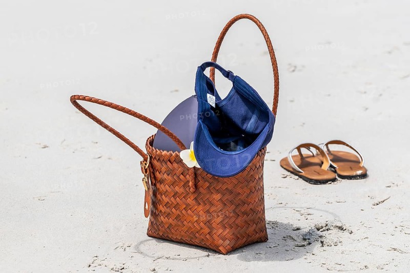 Handbag and sandals in the sand, Koh Larn, Thailand