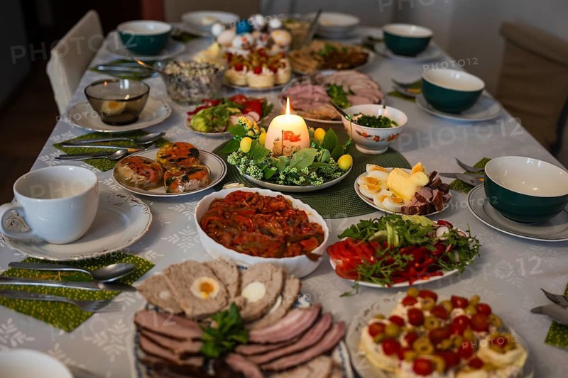 Traditional Easter festive table setting with eggs, zurek soup, and various dishes for a holiday breakfast celebration in Poland