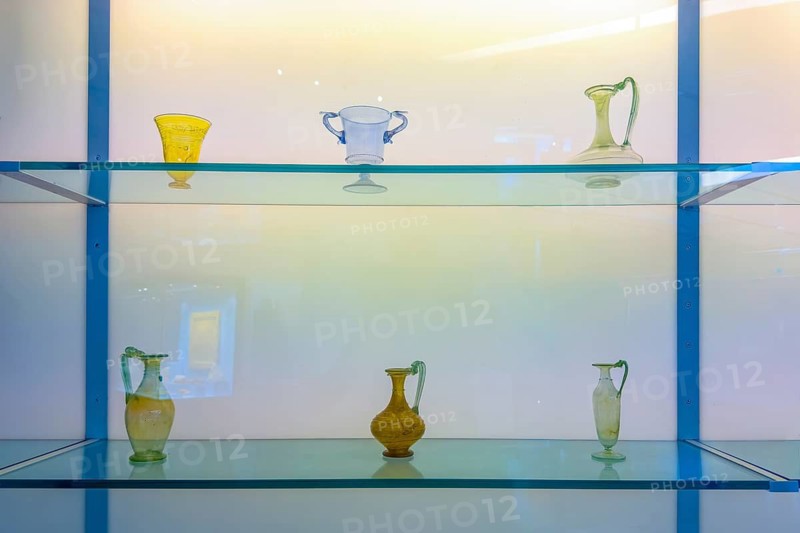 View of a display case with ancient Roman glass historical vases vessels from Roman times, Museum Aguntum, Lienz, East Tyrol, Austria
