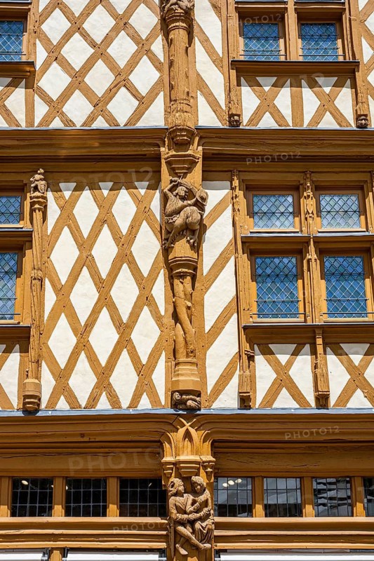 Magnificent medieval half-timbered art at the famous Maison d'Adam with artfully carved wooden figures on the outer wall, Angers, Maine-et-Loire, Pays de la Loire, France