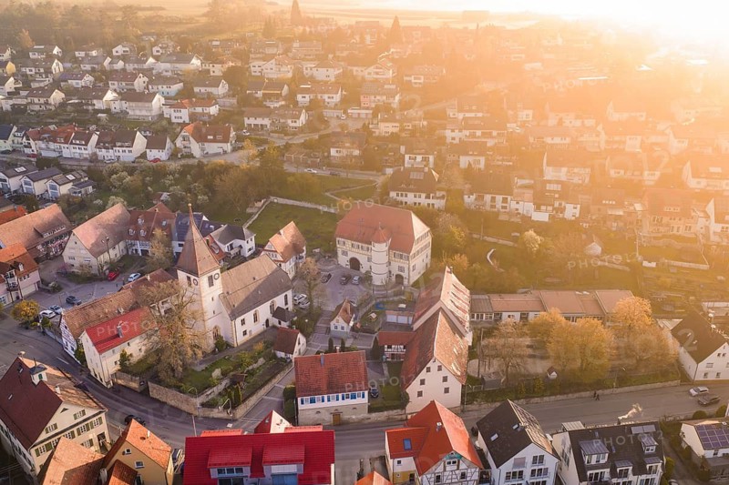 Village in evening light with colorful roofs and autumn colors from the air, Deufringen, Aidlingen, Heckengäu region, Böblingen district, Germany