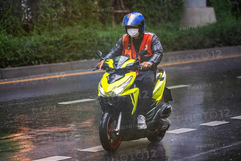 Motorcycle scooter in rain, Bangkok, Thailand