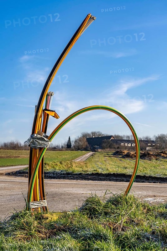 Fibre optic connection, empty conduits protrude from the ground along a dirt track, into which the actual fibre optic cable is later blown and connected to the respective house connection or distributor, provision of fast Internet in rural areas, in the south of Mülheim an der Ruhr, North Rhine-Westphalia, Germany