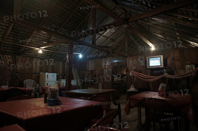 Rustic restaurant with wooden furniture and cozy lighting, San Lorenzo, Ecuador