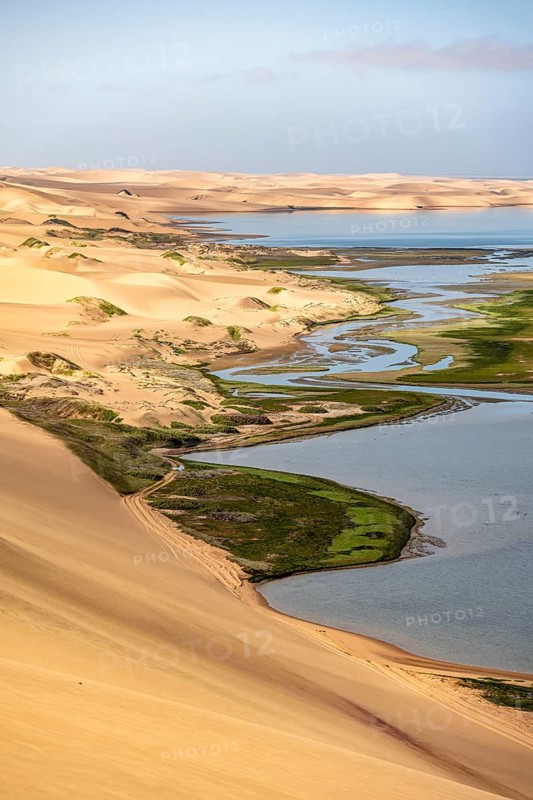 Sand dunes and sea, Sandwich Harbour Atlantic coast and lagoon, Namib Naukluft Park, Namib Desert, Namibia