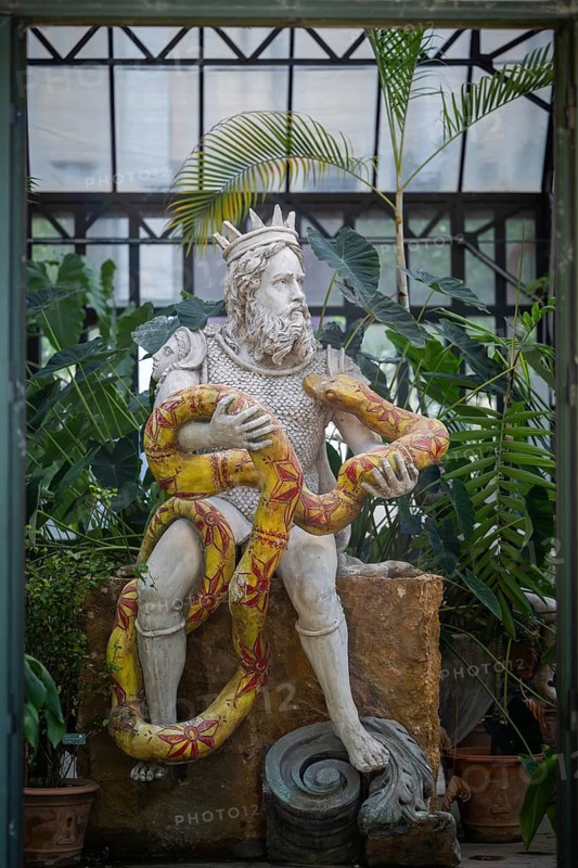 Genius of Palermo or Genio di Palermo, patron saint of the city of Palermo, modern sculpture by Domenico Pellgrino, interior view of a large greenhouse, Palermo Botanical Garden or Orto Botanico, Palermo, Sicily, Italy