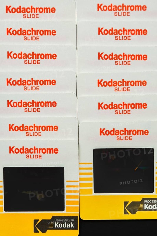 Close-up of two rows of neatly arranged old 1980s 35mm Kodak Kodachrome slides mounted in yellow and white cardboard frames with English wording, Studio Composition, Quebec, Canada