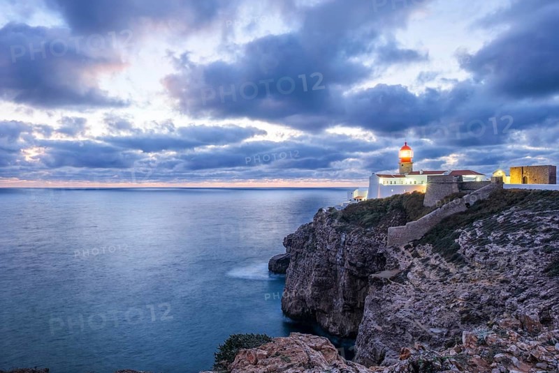 View of the Lighthouse of Cabo de Sao Vicente in Sagres, Algarve, Portugal, at evening with wide seascape and Atlantic ocean