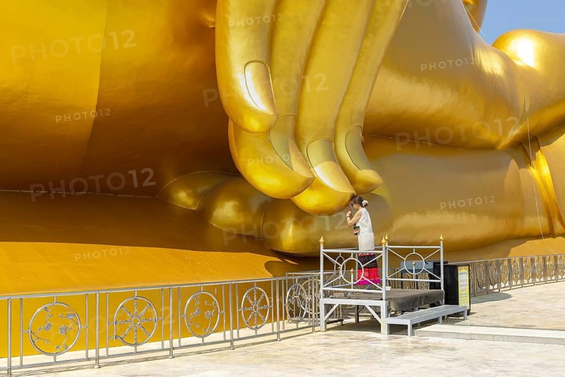 Largest Buddha statue in Thailand (Luang Pho Yai), Thai woman, Wai gesture (traditional gesture of respect, greeting or thanks), Wat Muang, Ang Thong, Amphoe Wiset Chai Chan province, Thailand