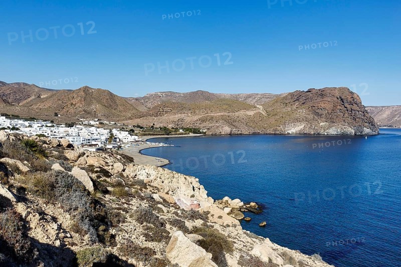 Rocky coast, arid volcanic landscape, white village, Cabo de Gata-Nijar nature park Park, Las Negras, Nijar, Almeria, Andalusia, Spain
