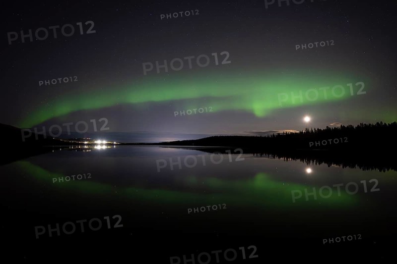 The Northern Lights (Aurora borealis) reflected in a forest lake, Gällivare, Norrbotten, Lapland, Sweden, October 2023