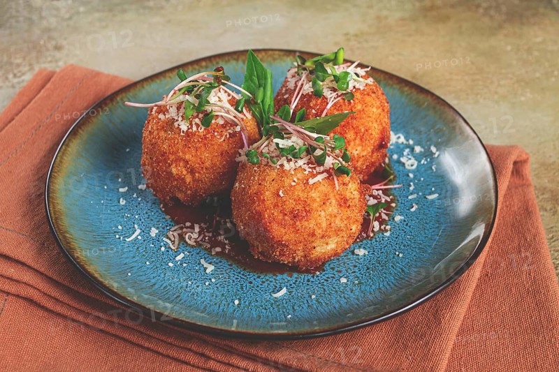 Crispy Arancini appetizer, with parmesan cheese and microgreens, plate, tomato sauce, homemade, no people