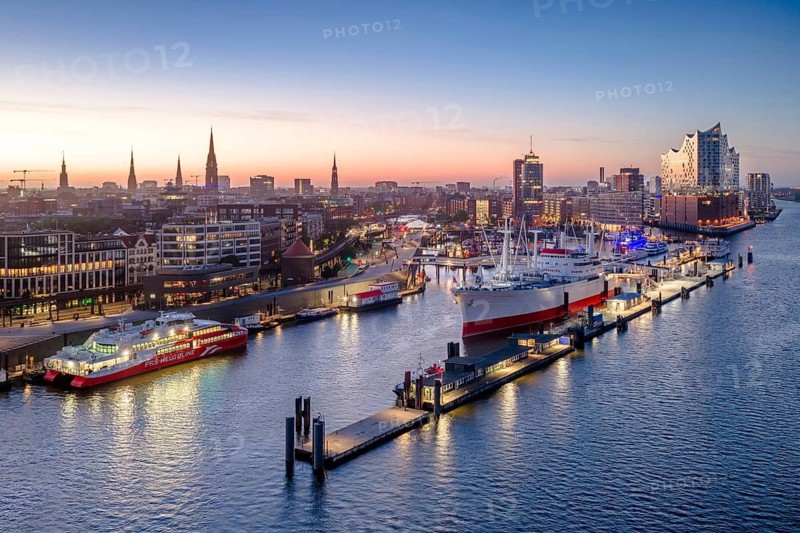 Aerial view of Landungsbrücken (Jan Fedder Promenade) at sunrise on the Elbe with Elbe Philharmonic Hall and Cap San Diego, Hamburg, Germany