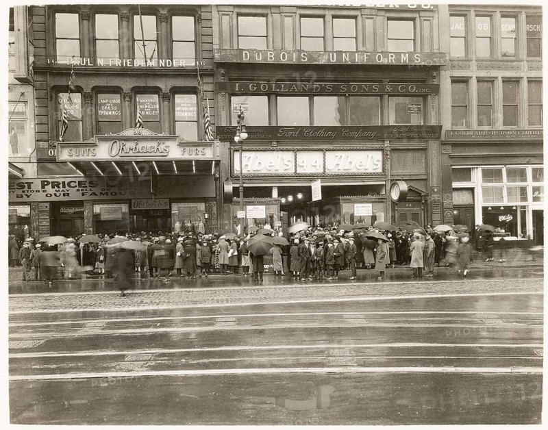 New York, 44 East 14th Street, Manhattan, Soho, USA, rain, people in front of shops with umbrellas on a rainy day on a busy street, 1940s