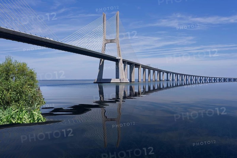 Cable-stayed Vasco da Gama Bridge reflecting in Tagus River, Lisbon, Portugal