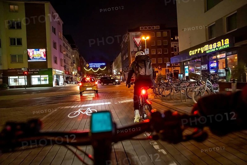 Cycling in the city, in the dark, in the evening, inner-city road, bicycle road, two-wheeler traffic has priority, 30 km/h zone, cyclist perspective, Essen, North Rhine-Westphalia, Germany