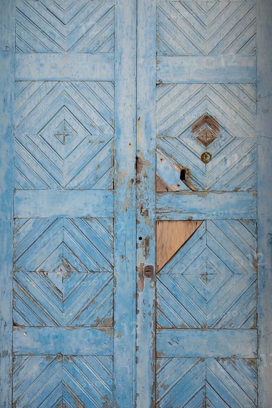 Worn, light blue painted wooden door, Malfa, Salina, Aeolian or Lipari Islands, Southern Italy, Italy
