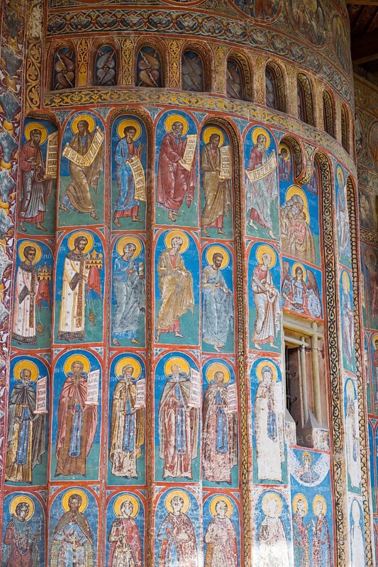 Wall with holy figures on magnificent frescoes in blue and red accents, exterior view, Saint George Monastery, Voronet Monastery, UNESCO World Heritage Site, Suceava District, Bukovina Region, Moldova, Romania