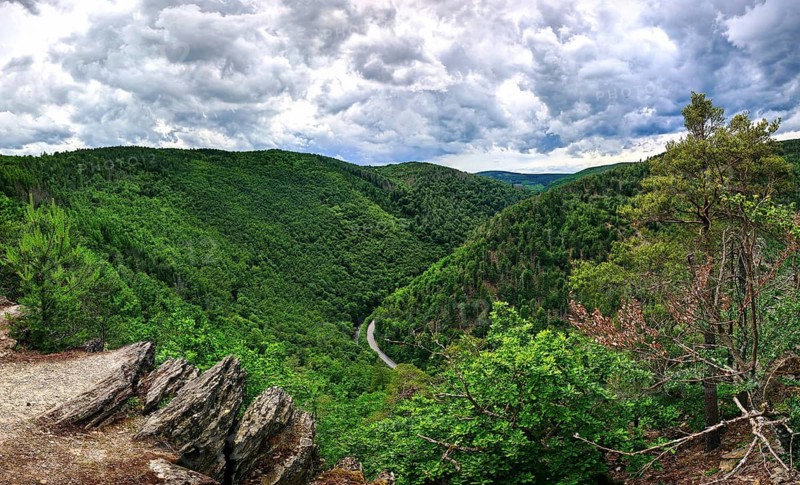 Panoramic view from Elisabethfelsen of a wooded valley under a dramatically cloudy sky, hiking in spring, Bad Blankenburg, Schwarza Valley nature park Reserve, Thuringian Forest Nature Park, Thuringian Slate Mountains