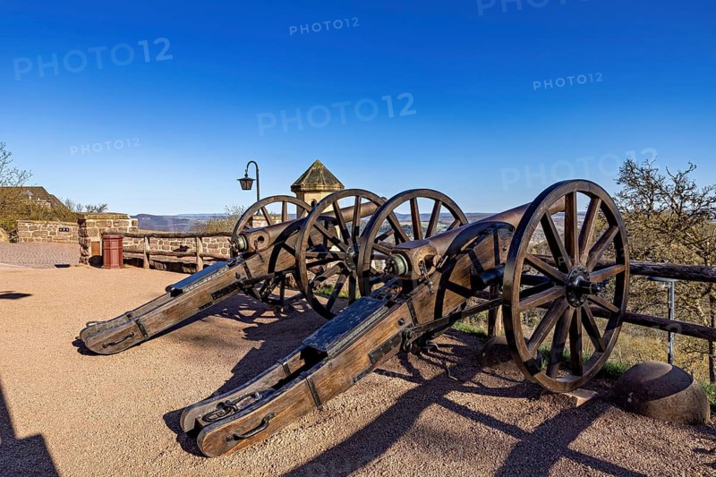 Two historic cannons on a sandy path with a view under a clear blue sky, The cannons on the Wartburg entrenchment near Eisenach in Thuringia