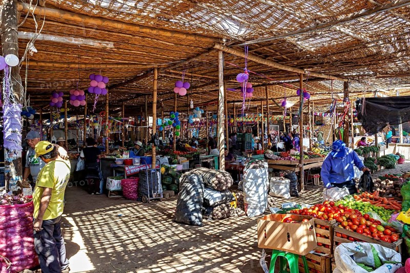 Indoor market with crowded stalls and colorful decoration, market and market stalls in the streets of Nasca in Peru