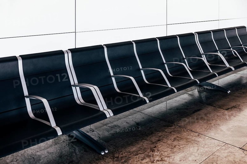 Empty black seats in waiting area at the airport