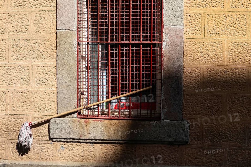 A mop is chained to a window grille in Barcelona, Spain