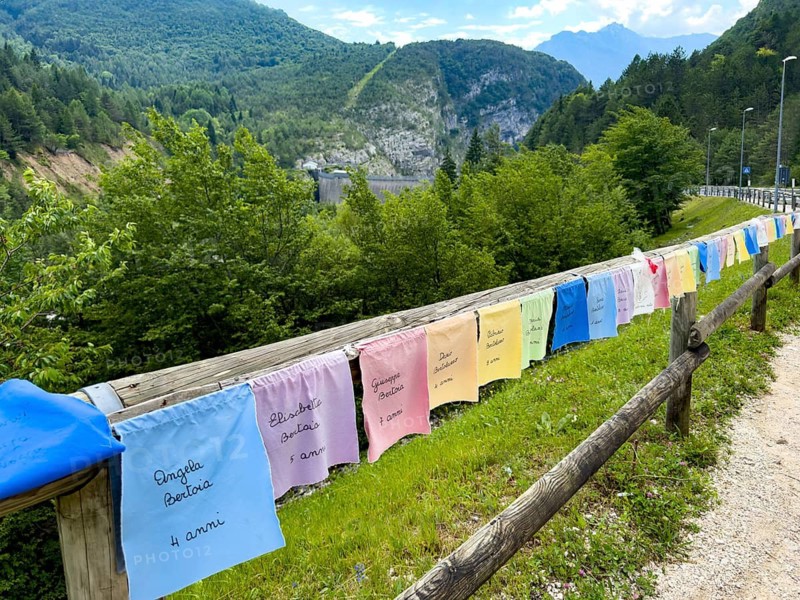Memorial flag with name and age from 1963 in the disaster of Longarone Vajont due to landslide from Monte Toc in reservoir after tidal wave over Vajont dam fatally injured children, Longarone, Veneto, Italy