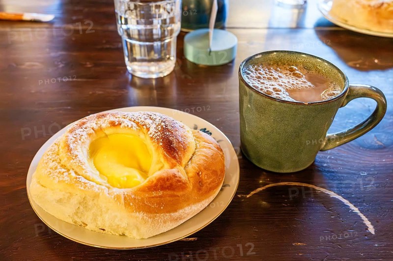 Cinnamon roll filled with vanilla cream and a cup of coffee, Henningsvaer, Lofoten, Norway