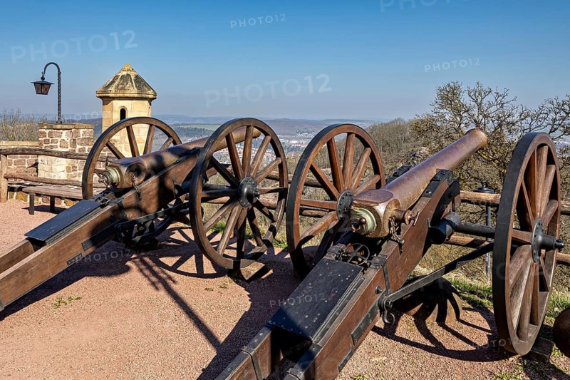 Two historic cannons on a fortress with a view of an extensive landscape under a clear sky, The cannons on the Wartburg ski jump near Eisenach in Thuringia