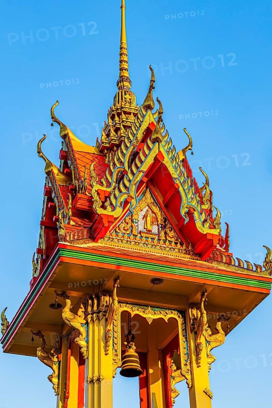 Artfully decorated bell tower with golden ornaments and delicate roof architecture, Koh Kret river island, Bangkok, Thailand