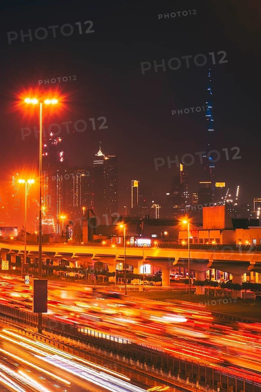 Panorama Dubai heavy night night traffic on Sheikh Zayed Road after work rush hour traffic. Light trails lead to the Burj Khalifa and Downtown Dubai cityscape at night landmarks skyline