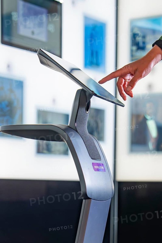Hand operates a modern touchscreen in an exhibition, Robolutions museum robot, Marchivum, Mannheim, Germany