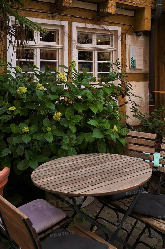 Table, sitting area, in front of Dreigiebelhaus, half-timbered house, market square, old town, Besigheim an der Enz, Baden-Württemberg, Germany