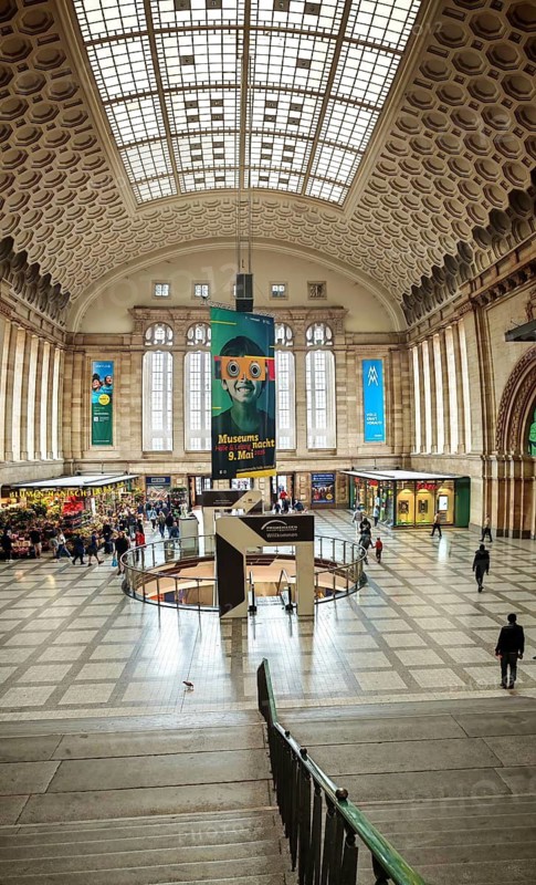 Large station concourse with impressive architecture and numerous people in an urban environment, train station, Leipzig main station