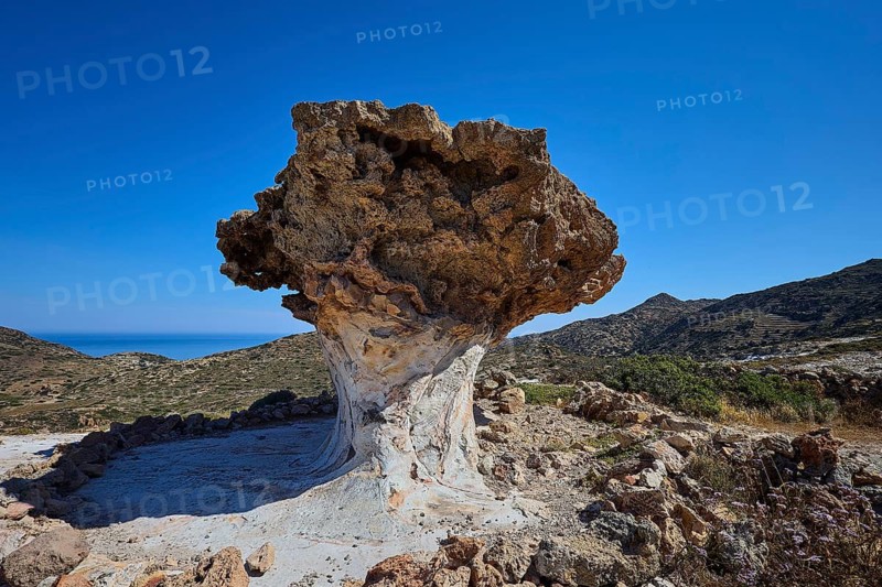 Impressive rock formation rises in front of an extensive mountain range, mushroom rocks, mushroom rock, bizarre rocks, rock formation, Skiadi, Kimolos, Cyclades, Greek Islands, Greece