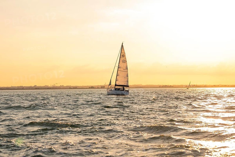 Sailing boat on calm water at sunset, peaceful atmosphere, Howth, Ireland