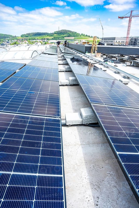 Long rows of solar panels on a roof under a clear blue sky, PV Assembly, Perrot, Calw, Germany