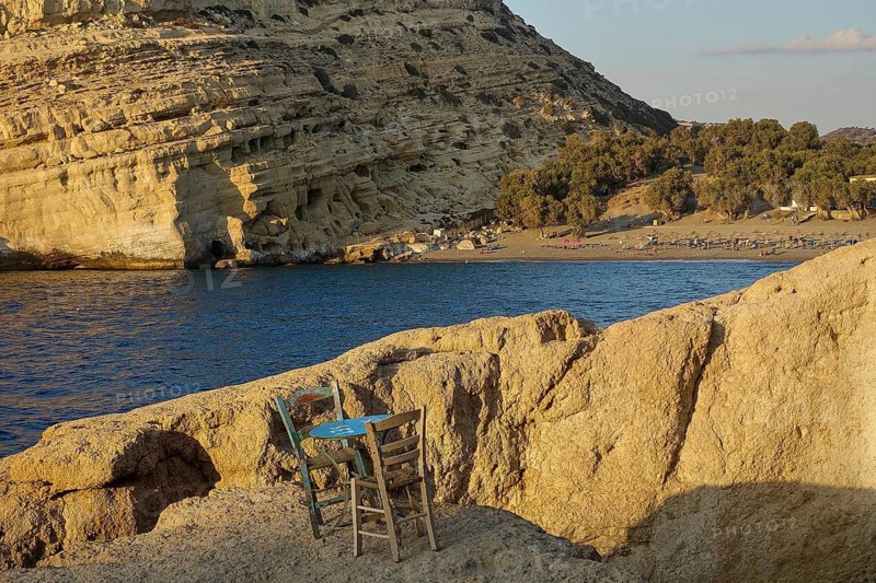 Neolithic caves, former hippie paradise, empty chairs on a rock by the sea, peaceful and natural environment, Matala, south coast, Crete, Greek Islands, Greece