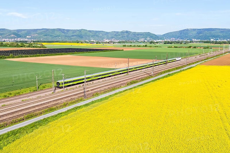 Aerial view of Flixtrain long-distance railway train on the Mannheim—Heidelberg railway line in Edingen, Germany
