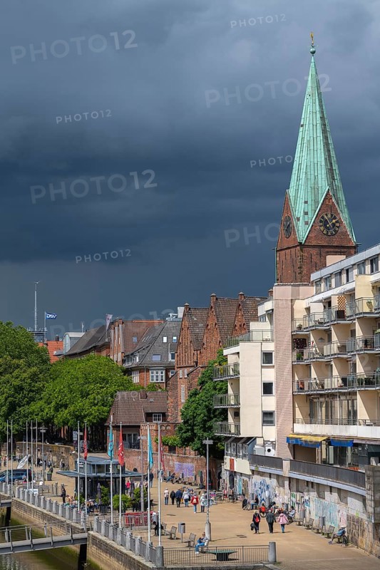 Spelt rain clouds over the Schlachte, Hanseatic City of Bremen, Weser, Weser promenade, waterfront, old town, harbor, promenade, gastronomy, restaurants, cafés, beer gardens, maritime flair, cityscape, tourism, walking, water edge, promenade, culture, leisure, northern Germany, sights, St. Martini church, historic waterfront, river panorama, enjoyment, maritime heritage, city life, Weserufer, apartments, row of trees, sunshine, city-state, Germany